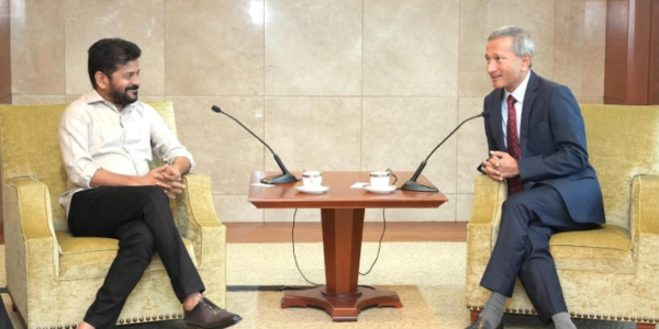 Telangana Chief Minister A. Revanth Reddy and Singapore Foreign Minister Vivian Balakrishnan shake hands during a meeting.