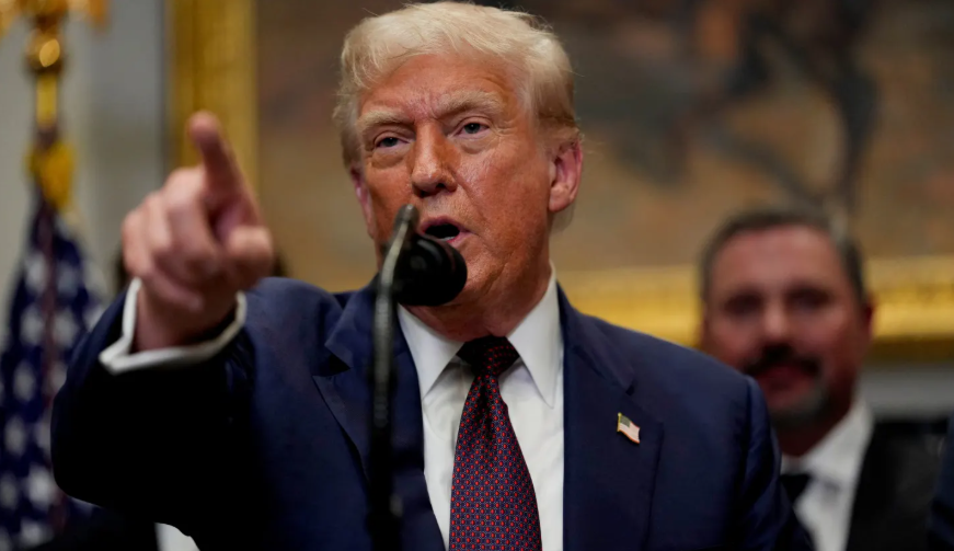 Donald Trump speaks and points during a press briefing in Washington D.C.