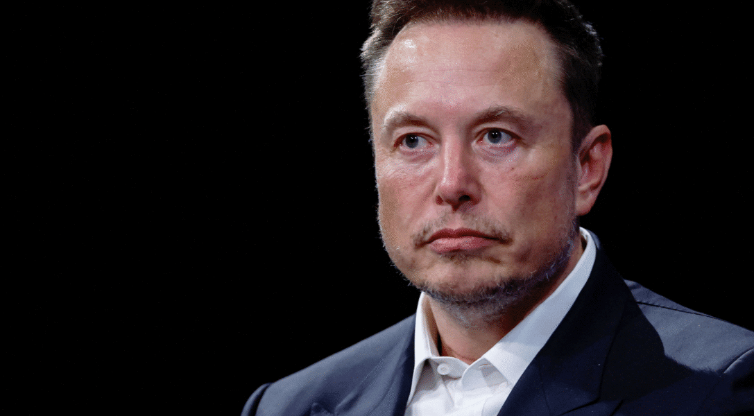 Elon Musk speaking at a technology conference, highlighting his leadership and economic influence in global industries