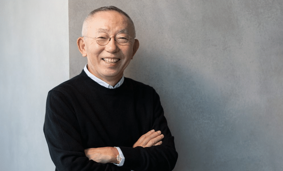 Tadashi Yanai, CEO of Fast Retailing, at a Uniqlo store opening, exemplifying global retail leadership and economic influence