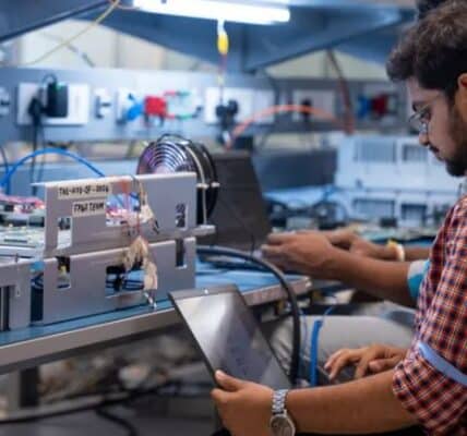Indian engineer working on semiconductor chip design and manufacturing equipment.